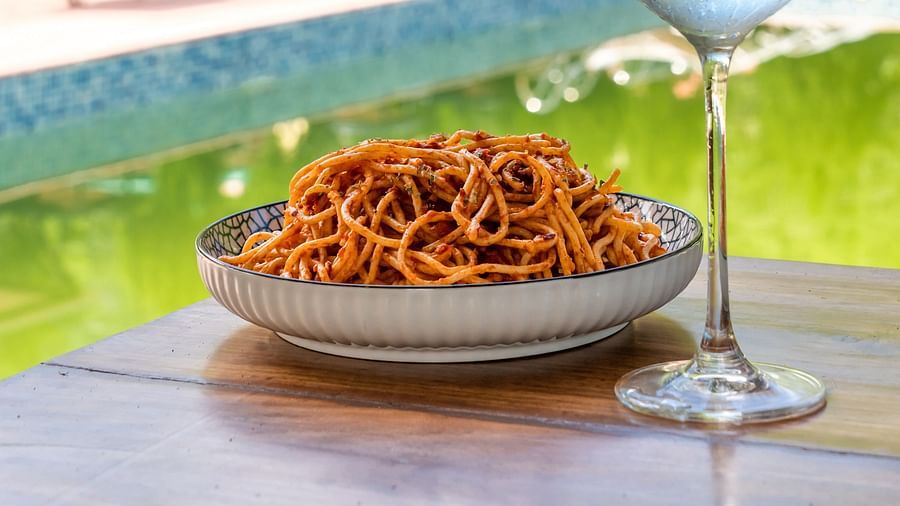 a bowl of spaghetti served with a cold beverage beside it - Neer Ganga Resorts