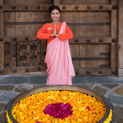 Women Folding Hands to Welcome Guests