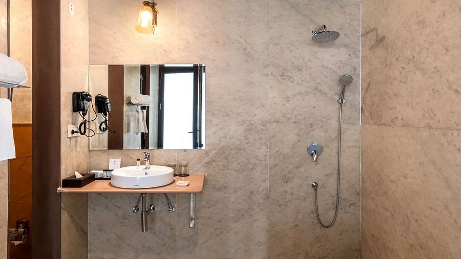 Elegant bathroom with ambient lighting and private plunge pool at Kesar Bagh Palace.