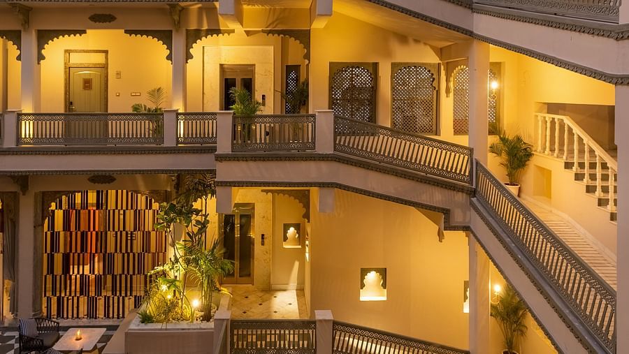 An overview of a courtyard with the inside of the building in view - Manuscript - Jhilwara Haveli, Udiapur