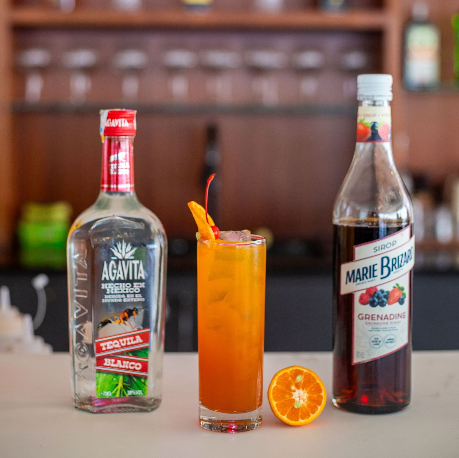 A cold beverage placed between bottles of Agavita Tequila and Marie Brizard at Mandala Norling Lords Prime, Kathmandu.