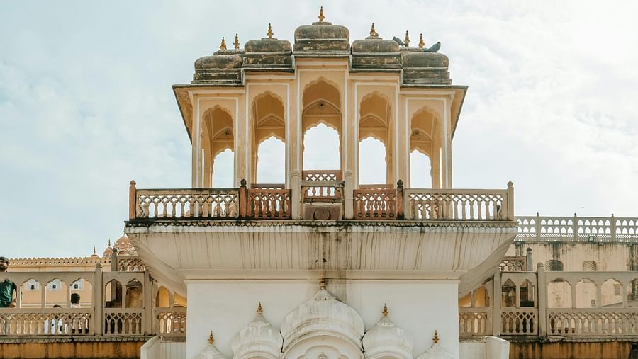 Facade of a fort with ochre walls and marbled finish over the entry during the day