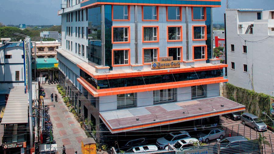Facade view of Benzz Park, Vellore on a bright day featuring a seven storey building.