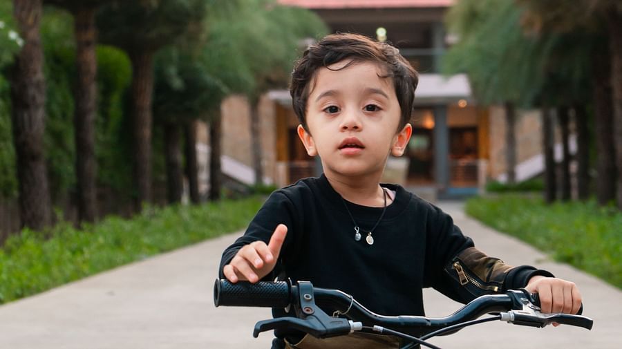 A little kid cycling on the track at Crescent spa & resort, Indore