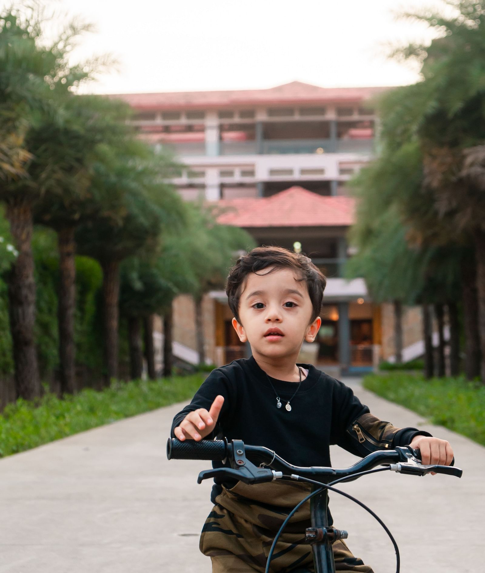 A little kid cycling on the track at Crescent spa & resort, Indore