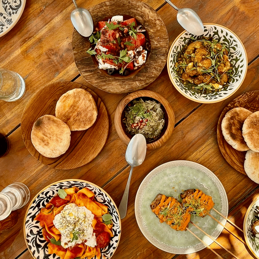 A top down view of numerous dishes kept on the table of Middle Eastern cuisine at one of the Souq Waqif restaurants.