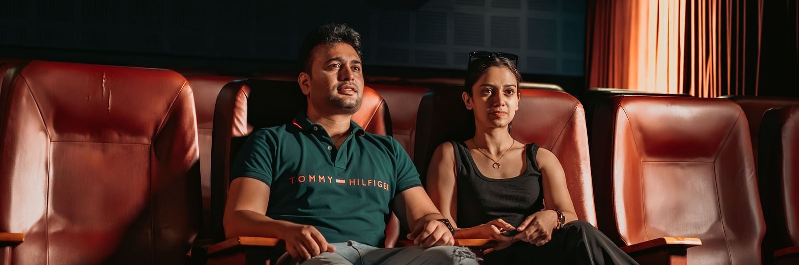 A couple enjoying movie time and having fun in the mini theatre at Crescent Spa & Resort, Indore