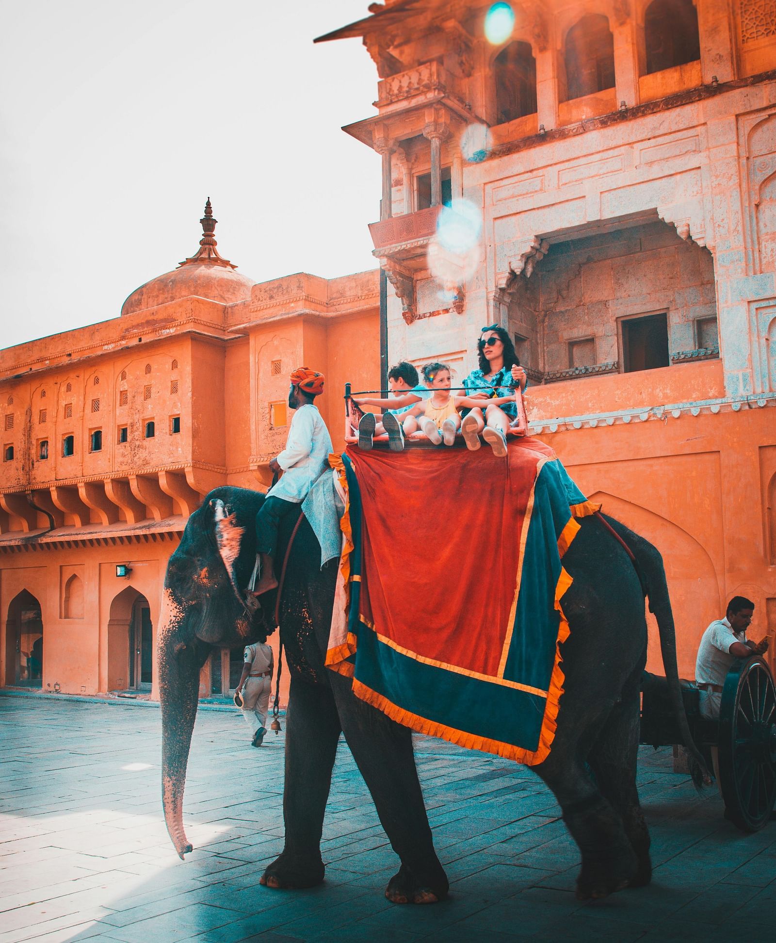 Tourists enjoying an elephant ride at an Indian palace