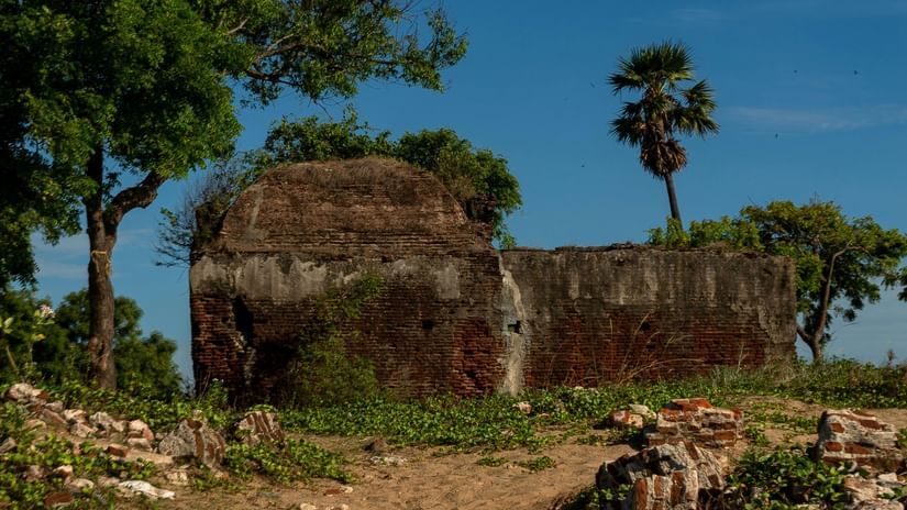 A view from afar of a fort in the distance with a pathway leading to it - Thirumayam Fort History.