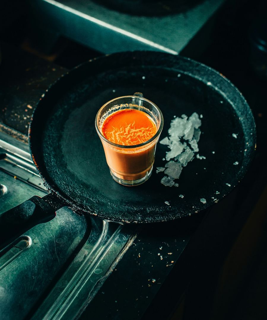 alt-text Image of a steamy hot Indian tea, accustomed in a dark tint