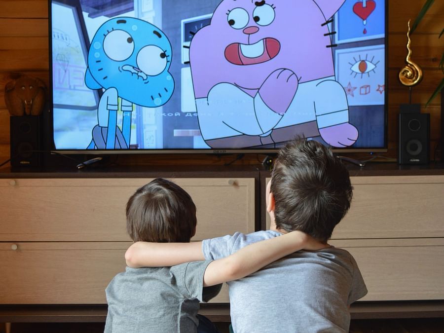 Heritage Village Goa - two children putting their arms around each other while they re watching cartoon