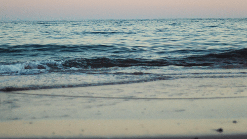 An overview of Galgibaga Beach, Goa in the evening with water overlapping the beach