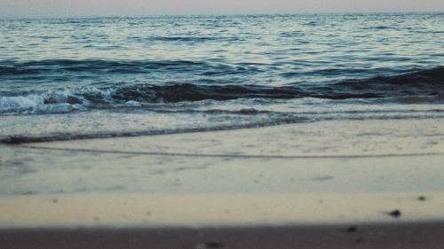 An overview of Galgibaga Beach, Goa in the evening with water overlapping the beach