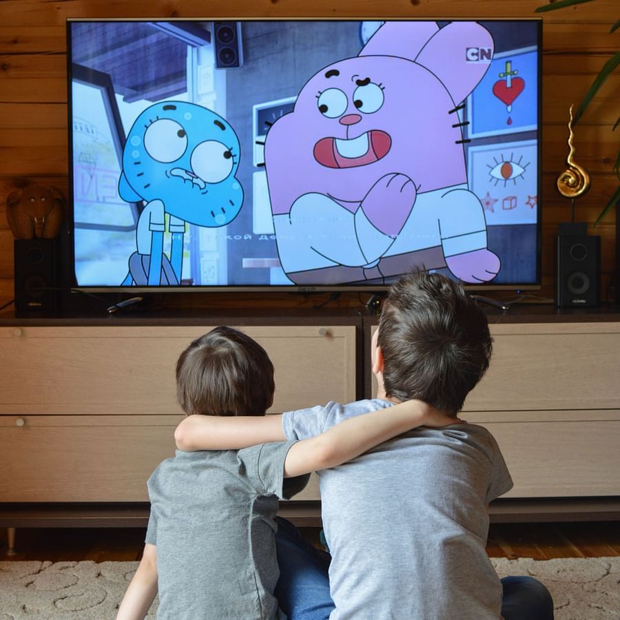Heritage Village Goa - two children putting their arms around each other while they re watching cartoon