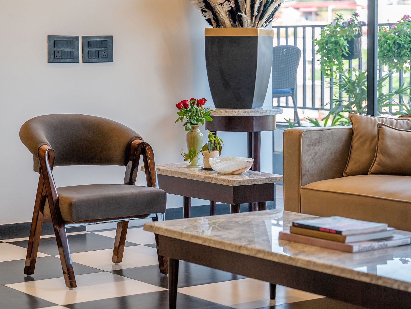 Side view of a well-lit interior of a lobby or lounge area, furnished with a mix of seating and a table. - Vishranti Hotel Dehradun.