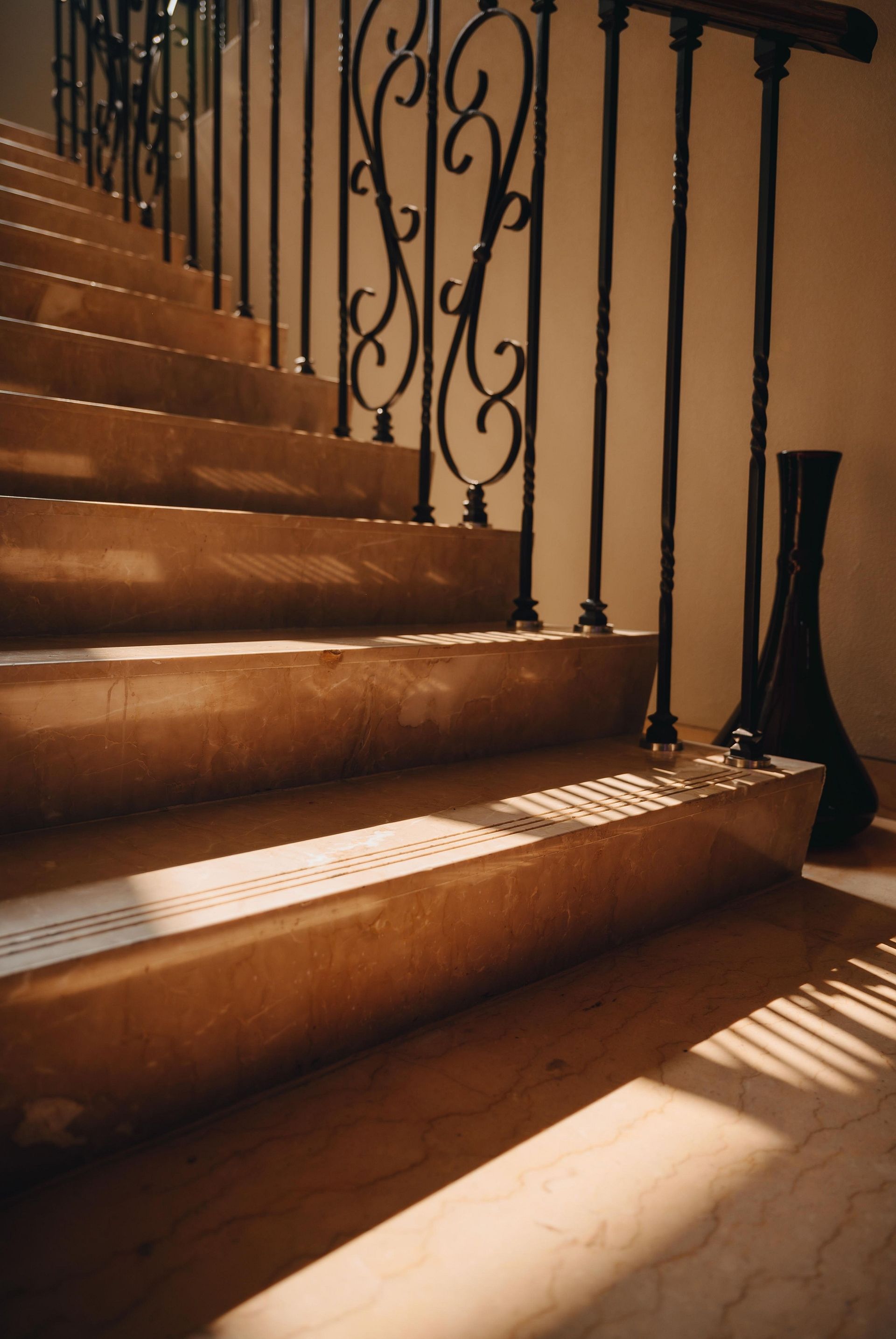 Portrait, close up shot of stairs with vintage handrail and ambient natural lighting at Karma Chalets.