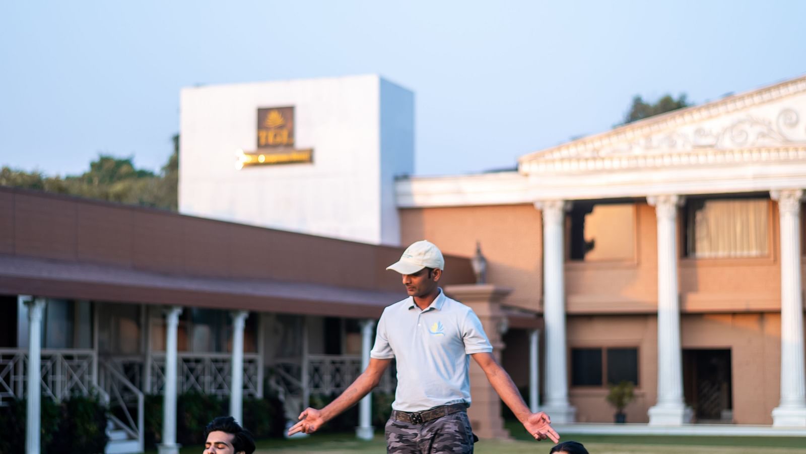  Guests practising yoga on the lawn during wellness activities at The Grand Legacy Resort and Spa.