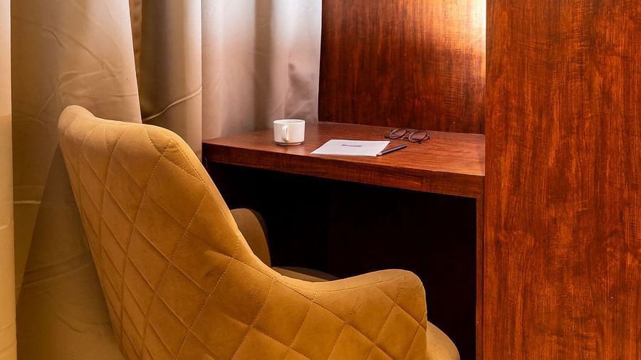 Workstation in the corner of the Premium Room with a chair and table.