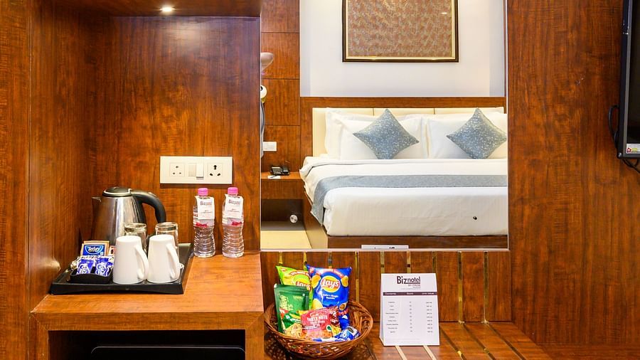 Corner wardrobe of Premium Room with essentials like safety locker, kettle, and mini fridge at Biznotel by Pride, Deoghar