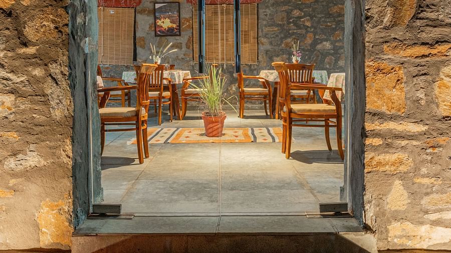 Stone corridor leading to a cozy guest room at Clarks Safari, Jawai.