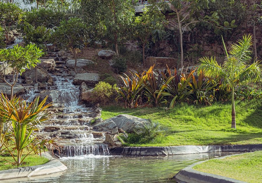 The waterfall joining the water body at the bottom - The Ananta Udaipur