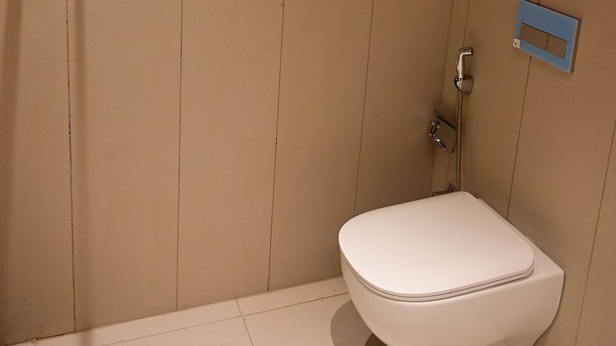 a modern bathroom featuring a commode at club charholi, pune