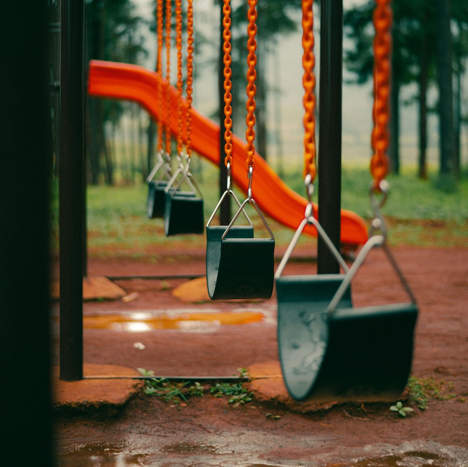 A close-up view of swings in the playground