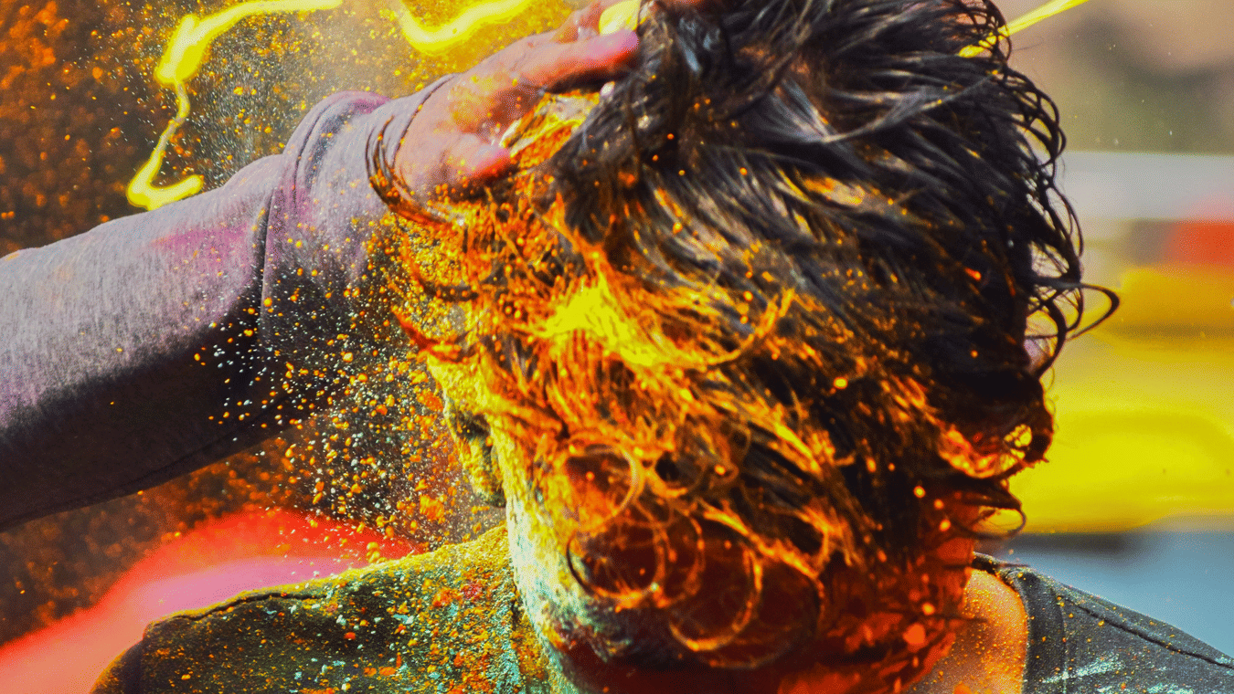 people celebrating with colours at a festival