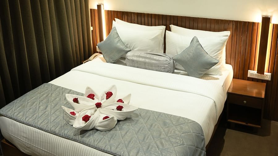 Side view of a double bed at Deluxe room at  Mango Leaf Lake Resort, Pune