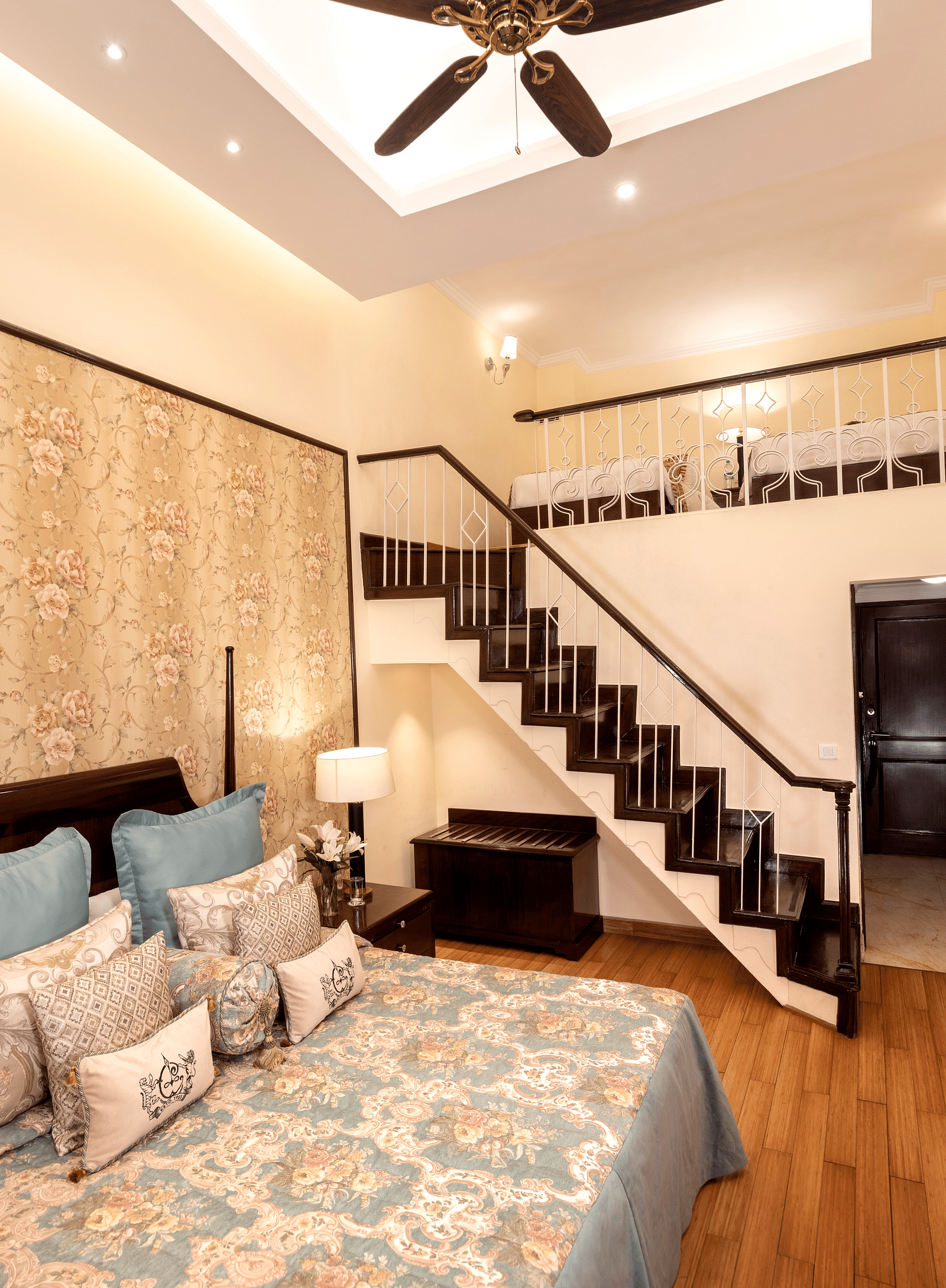 a brightly lit image of the Duplex Family Suite with a staircase leading to the upper floor at The Claridges Nabha Residence