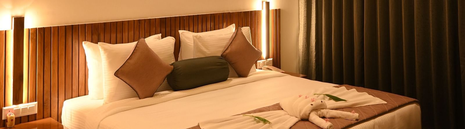 A double bed in the Deluxe Cottage at Mango Leaf Lake Resort, Pune