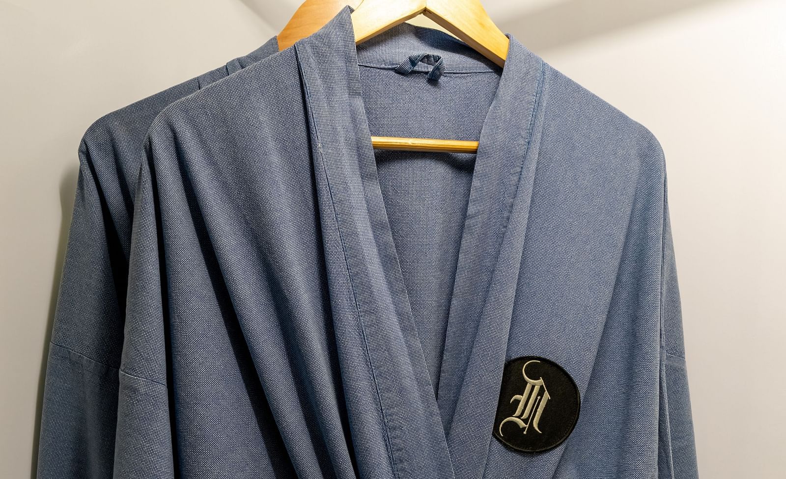 A close up shot of grey bathrobes hung in the wardrobe - Night Hotel Bangkok.