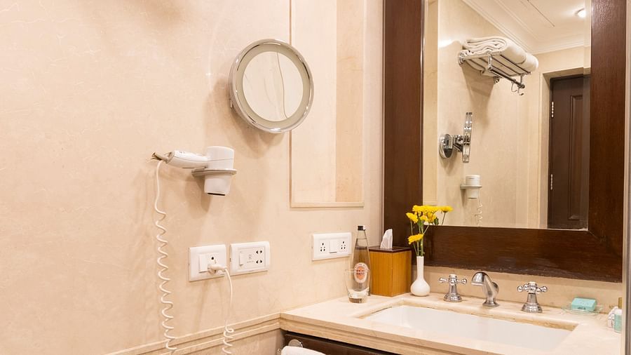 image of the bathroom with a mirror above the sink at The Claridges Nabha Residence