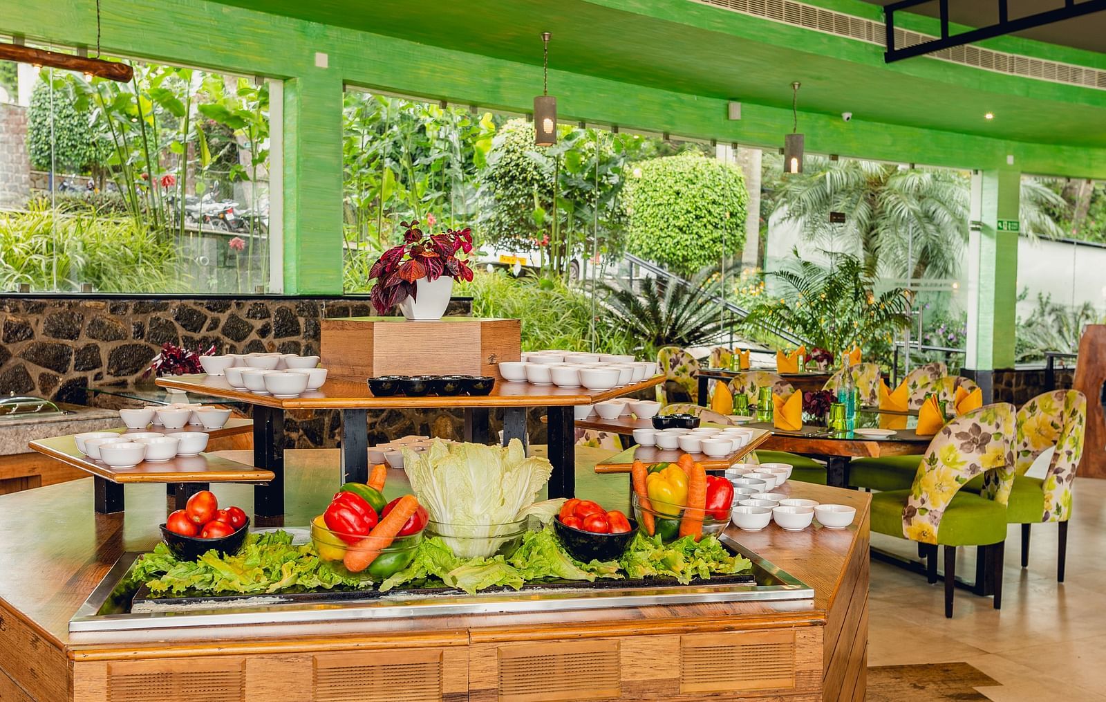 An image of a restaurant with a buffet spread, a chandelier and decorative items - Great Trails Yercaud by GRT Hotels