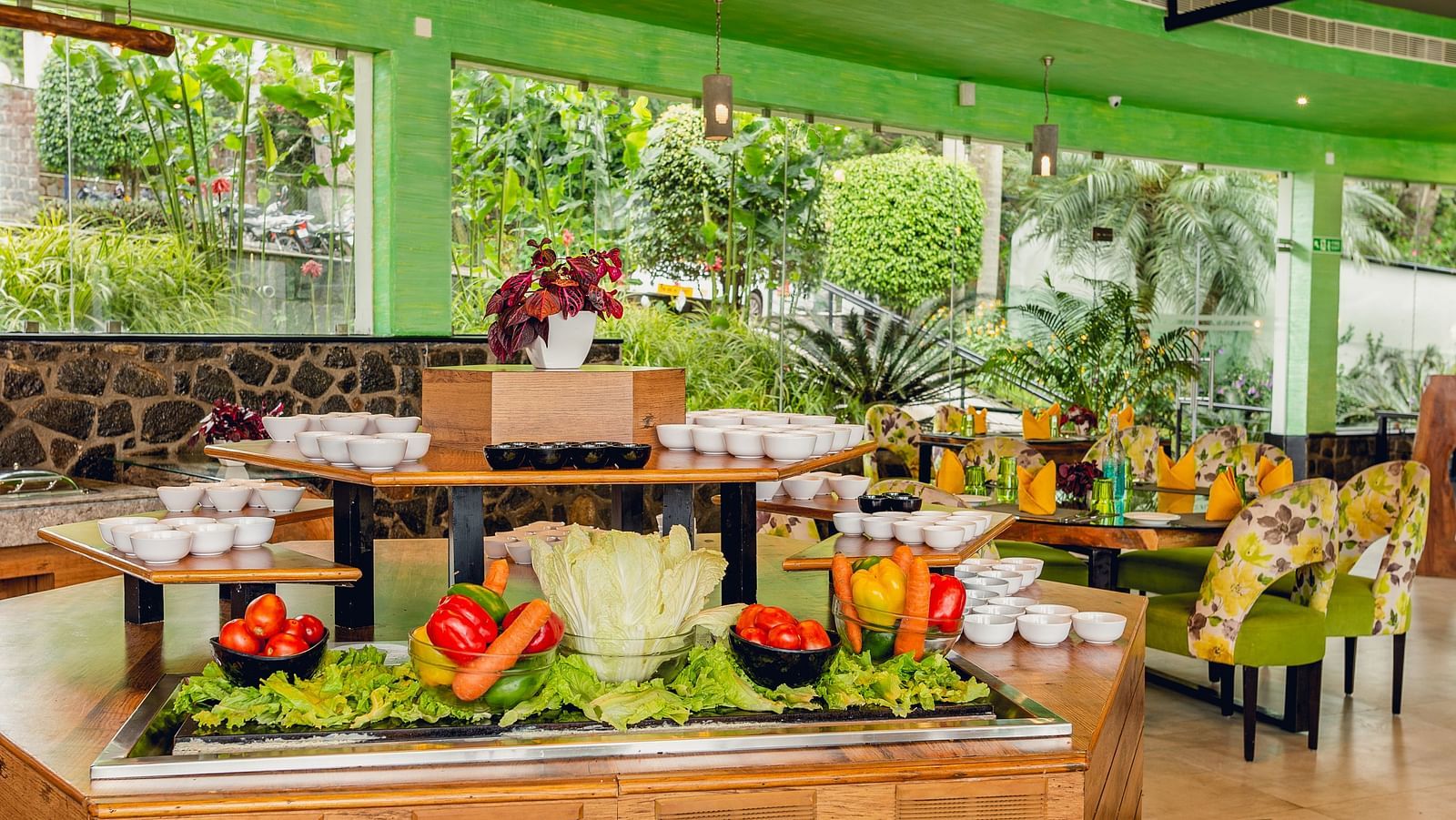 An image of a restaurant with a buffet spread, a chandelier and decorative items - Great Trails Yercaud by GRT Hotels