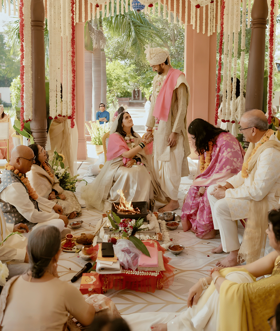 Wedding ritual in progress inside decorated hall at Umaid Palace during Charvi & Dhruv ceremony.