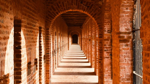 Redbrick shadowed cloister inside the Cellular Jail Museum - Light and Sound Show Port Blair Tickets.