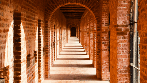 Redbrick shadowed cloister inside the Cellular Jail Museum - Light and Sound Show Port Blair Tickets.