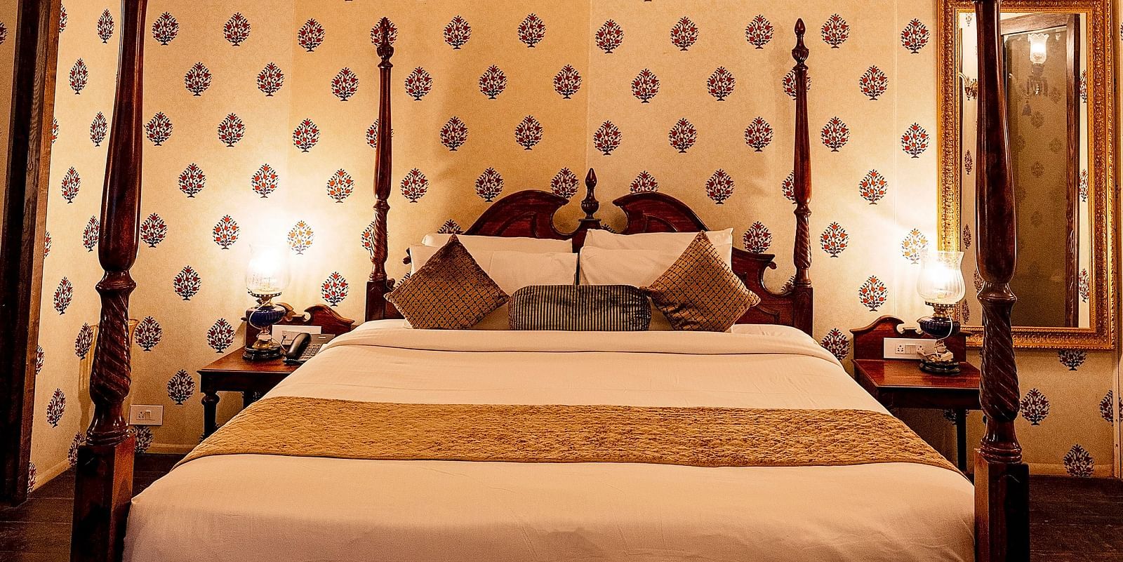 Image of a luxury tent with a bed and a chandelier above the bed Rajasthali Resort & Spa Jaipur.