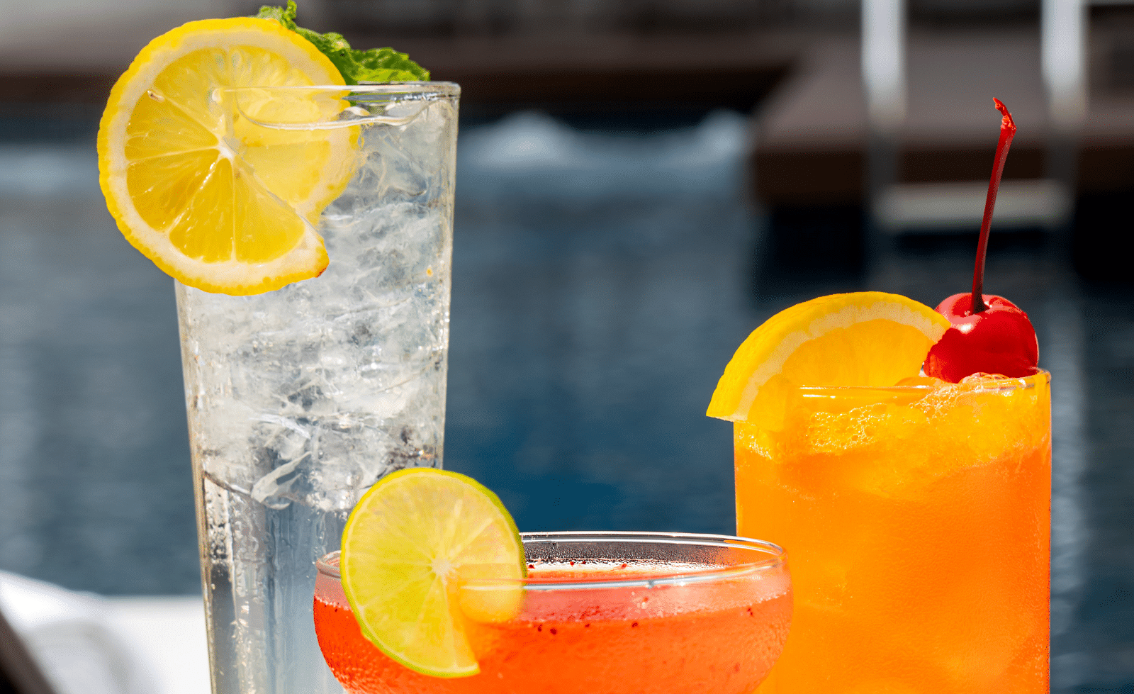A close up shot of cocktail drinks placed on a table - Night Hotel Bangkok.