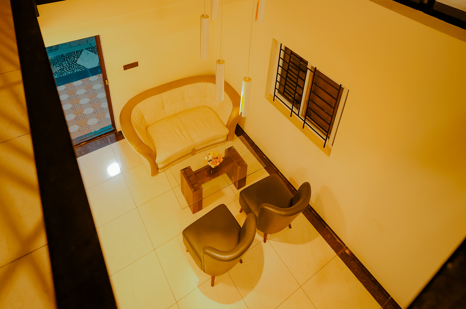 A balcony with a chair and a view, at Nirantara Resort & Spa.