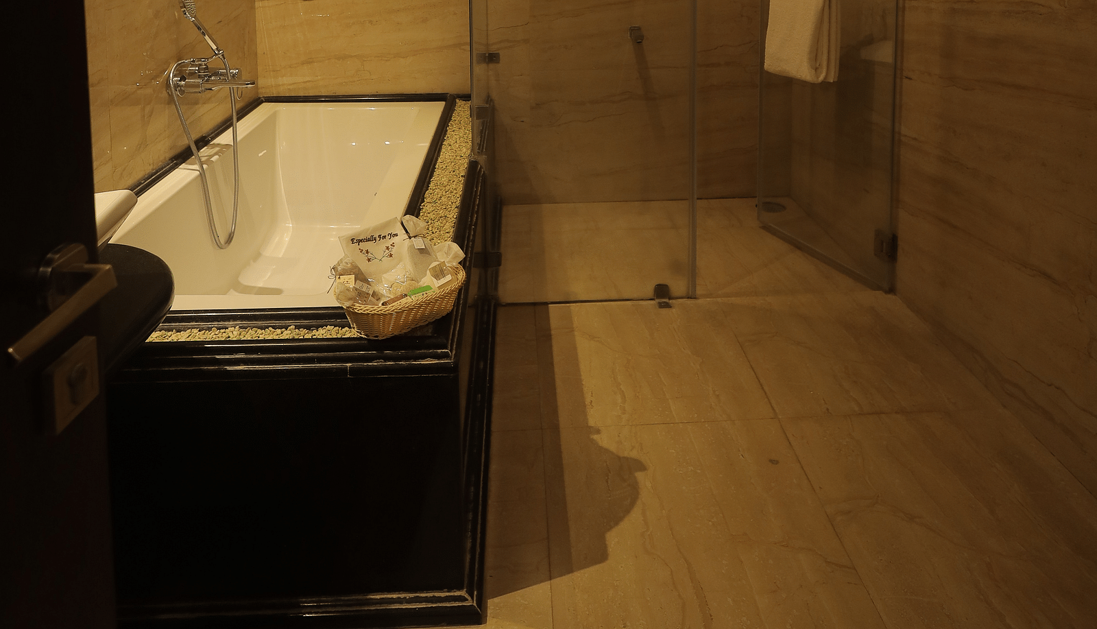 An image of a bathtub in a bathroom - Sathyam Grand Resort