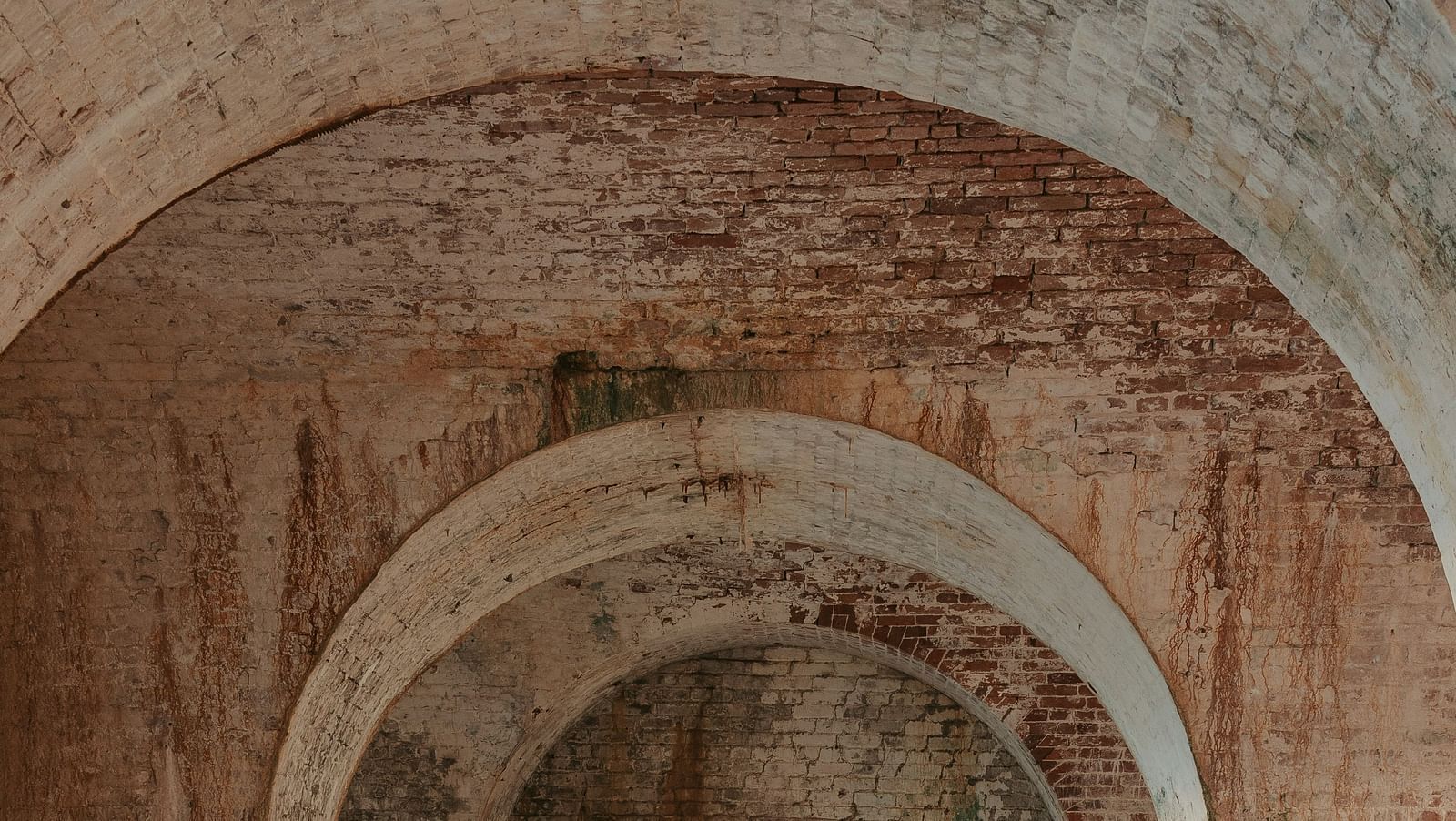 An overview of the interior of a fort with an arch in view