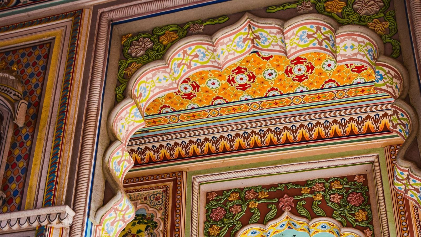an overview of an entrance to a building in Jaipur, Rajasthan with colourful paintings