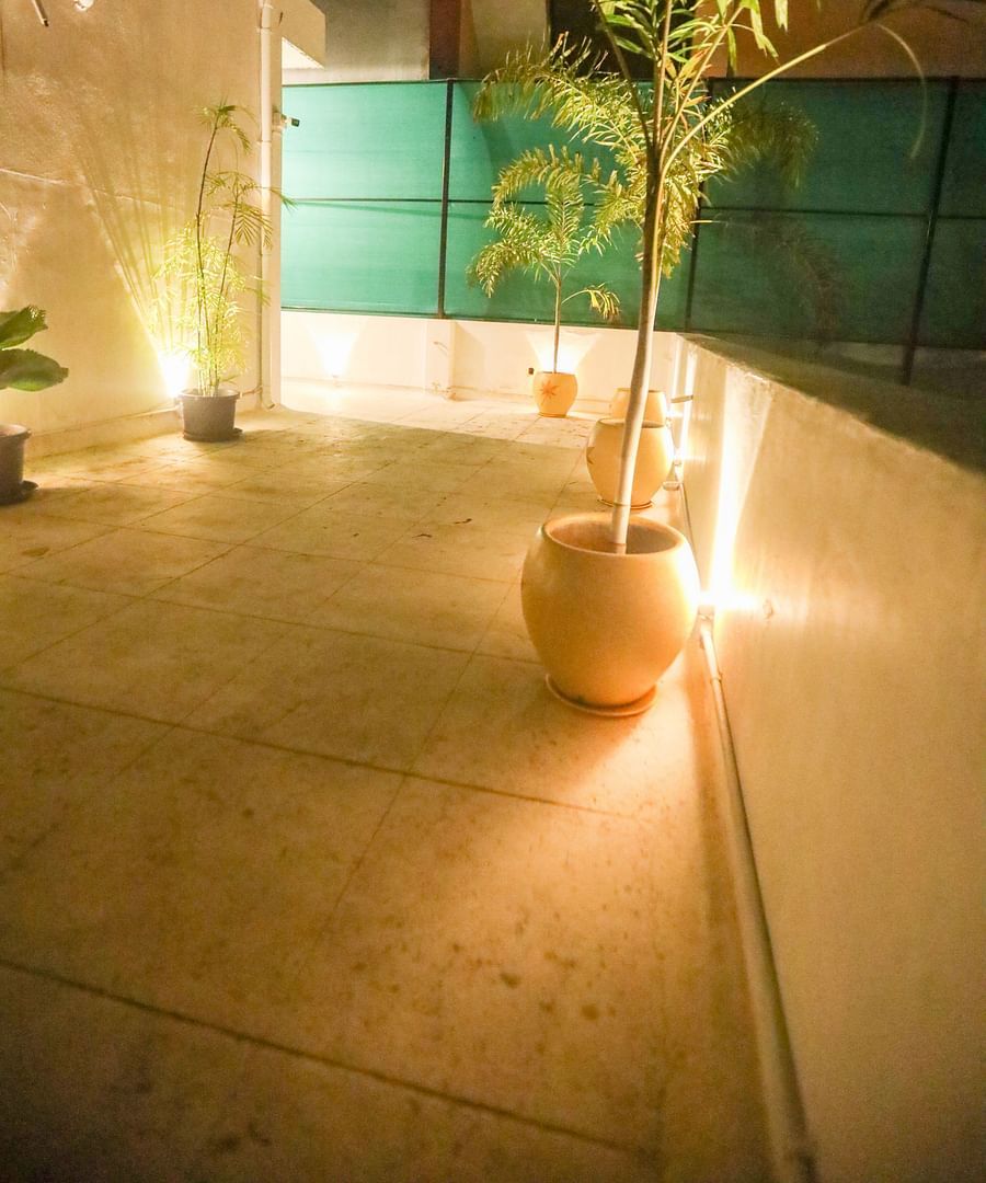 alt-text Terrace of the of la villas Heritage, pondicherry with flower pot and decorated with fairy light.