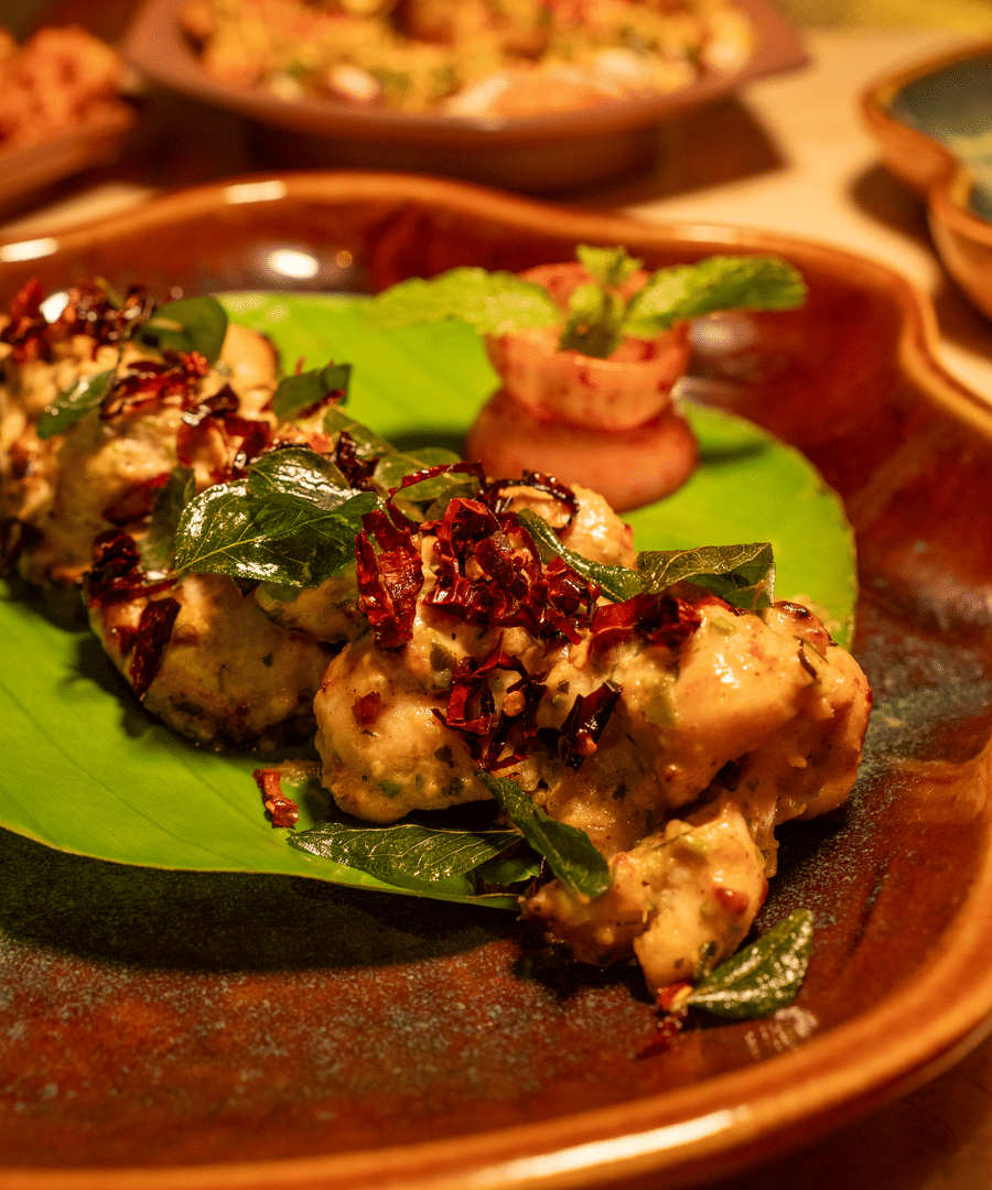 Close-up of a grilled appetiser served on a plate with garnish - Symphony Resorts -Symphony Resorts