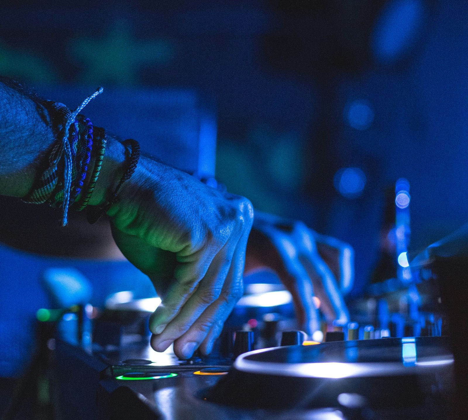 Under the disco lights, the DJ expertly manipulates the beats on his device, creating a pulsating rhythm that energises the dance floor.
