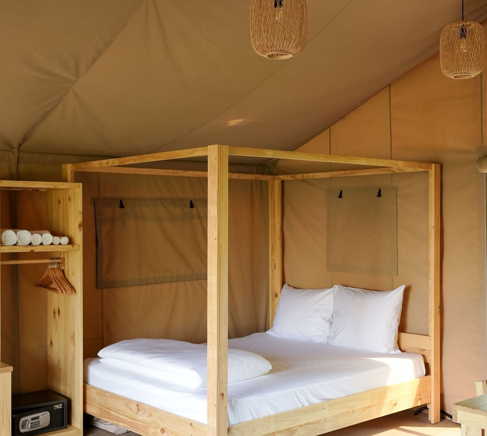  An interior view of the Mindful Tent at WoCAL Retreat Ke Ga, showcasing a bunk bed with wooden frame and simple furnishings for a comfortable stay.