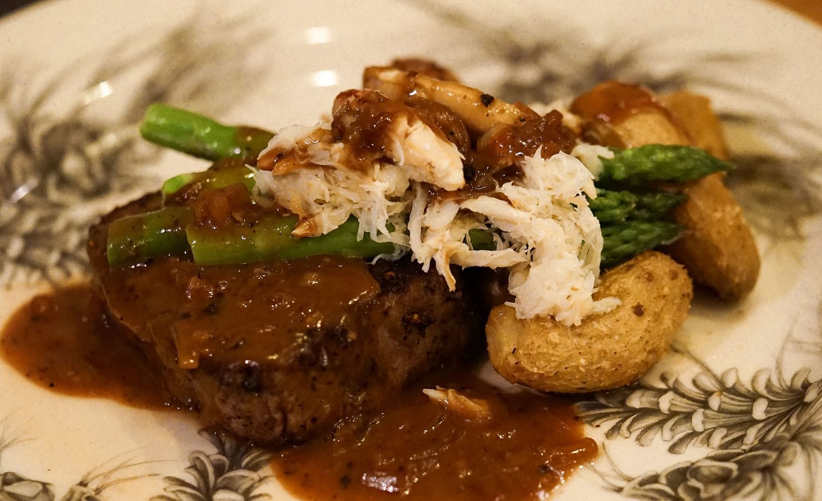 A mouthwatering gourmet dish featuring a tender cut of beef served with vegetables and a flavorful sauce - Brewery Gulch Inn & Spa