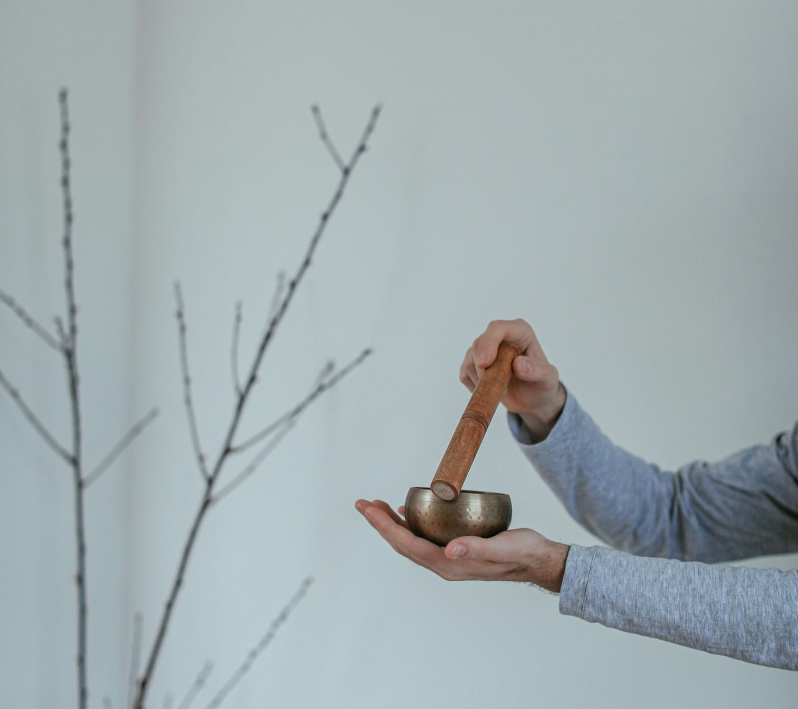 A close-up shot of a person using a healing bowl.